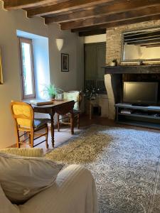 a living room with a table and a fireplace at Puyleger in Saint-Privat-des-Prés +1 photo
