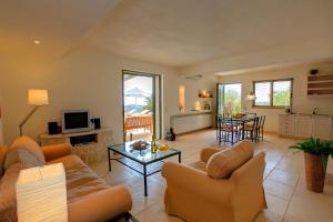 a living room with a couch and a table at Villa Asterias Ideales Resort in Kefallonia