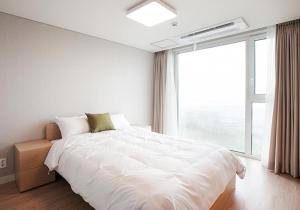 Säng eller sängar i ett rum på Jeju Sorang in Farms Village