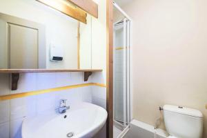 a bathroom with a sink and a toilet and a mirror at Quartier La Forêt - maeva Home - Appartement 2 pièces 6 personnes - Sélec 114 in Valmorel