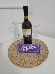 a bottle of wine and a pack of chocolates at Studio apartment Gigi in Zagreb