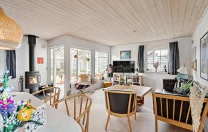 a living room with a table and chairs and a television at Holiday Home Nørre Nebel 9 in Nymindegab