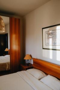 a hotel room with two beds and a mirror at Adagio House in Valdamonte