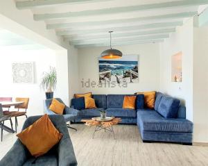 a living room with a blue couch and a table at Casa Roberto Altea in Altea