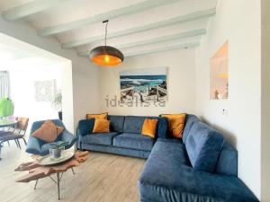 a living room with a blue couch and a table at Casa Roberto Altea in Altea