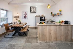a kitchen with a wooden table and a dining room at 3 Bed in Belford oc-cn065 in Belford