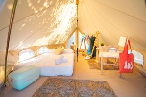 a bedroom with a bed in a tent at Kampaoh Tossa de Mar in Tossa de Mar