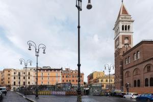 a city street with a clock tower and buildings at HospitalityRome Fashionable Apartment SanLorenzo in Rome