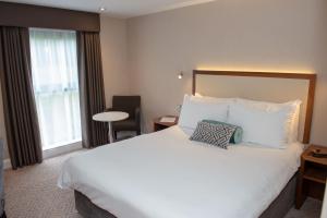 a hotel room with a large bed and a window at Best Western Appleby Park Hotel in Tamworth
