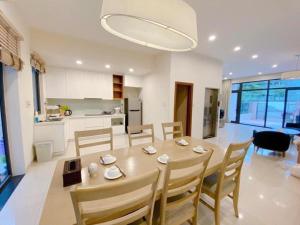下龍灣的住宿－Kim's Villa - 5 phòng ngủ siêu rộng - 100m đến Bãi Tắm，用餐室以及带桌椅的厨房。