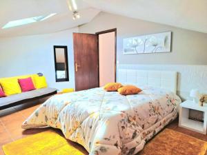 a bedroom with a large bed and a couch at One bedroom appartement with terrace and wifi at Santana 5 km away from the beach in Santana