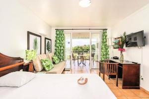 a bedroom with a bed and a desk and a living room at Village Sainte Luce, Martinique - maeva Home - Studio 3 personnes - Prestige MAE-2804 in Sainte-Luce