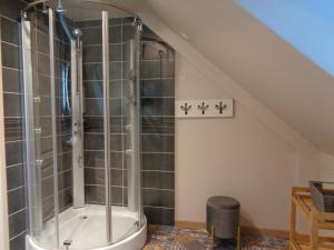 a bathroom with a shower in the attic at le gite de la douceur d'antan in Roquetoire