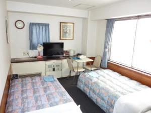 Tempat tidur dalam kamar di Otsuka City Hotel