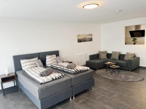 a living room with a bed and a couch at MY HOME N 35 in Villingen-Schwenningen