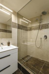 a bathroom with a shower and a sink and a tub at Cozy & comfortable apt walking anywhere you want SEN in Prague