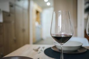 a glass of red wine sitting on a table at Cozy & comfortable apt walking anywhere you want SEN in Prague