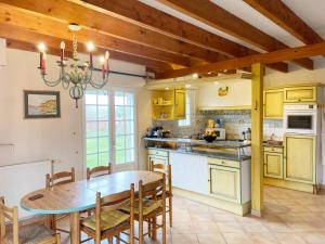 a kitchen with a wooden table and a dining room at Kerderff, longere entre plage et foret, TK30 in Carnac