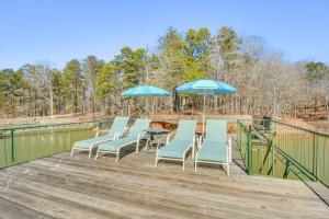 a group of chairs and umbrellas on a deck at Lake Hartwell Retreat with 2-Tier Dock and Boat Slip! in Seneca
