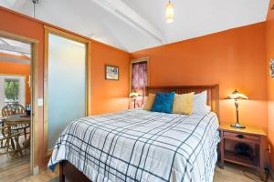 um quarto com paredes cor de laranja e uma cama em Bluemoon Vacation Rentals - Bluemoon Cottage em Ashland