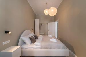 um quarto com uma cama branca e um candeeiro em Sigmund I levestate em Viena