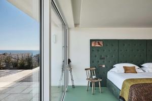 a bedroom with a bed with a green headboard at Cliff House Hotel in Ardmore