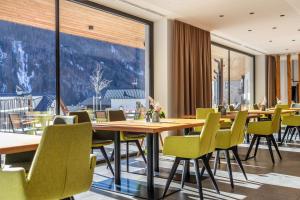 a restaurant with wooden tables and chairs and large windows at Stoana Apt 3-3 in San Giacomo +36 photos