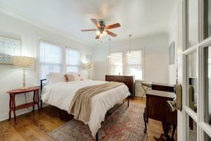 a bedroom with a bed and a ceiling fan at Classic Luxury Tudor And Garden Studio in Oklahoma City