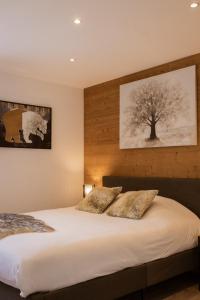 a bedroom with a bed with two pillows on it at Chalet Lova in Valloire