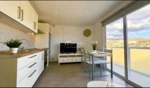 a kitchen with a table and a dining room at Penthouse Apartment Las Americas in Playa de las Americas