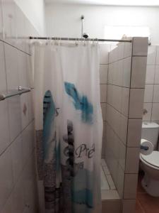 a shower curtain in a bathroom with a toilet at Maison d'une chambre avec terrasse et wifi a Fort de France in Fort-de-France