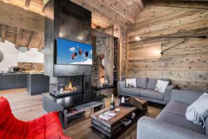a living room with a couch and a fireplace at Résidence Black Mountain - Pièces 784 in Les Allues