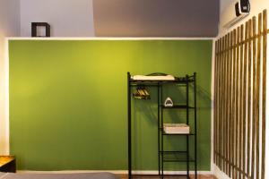 a green wall with a shelf in a room at La Nicchia in Cagliari