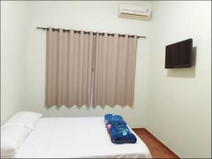 Una cama o camas en una habitación de Suíte privativa Gigá