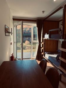 a dining room with a table and a window at Ben Nevis Inn Rooms in Fort William