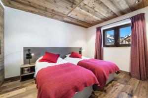 Duas camas num quarto com almofadas vermelhas em Résidence Fontany - Chalets pour 12 Personnes 044 em Les Allues