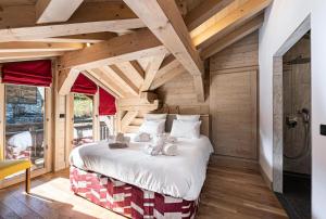a bedroom with a bed in a room with wooden ceilings at Résidence Saint Joseph - Chalets pour 11 Personnes 294 in Val-d'Isère