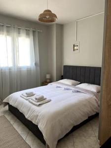 a bedroom with a large bed with towels on it at Letty's cozy flat apartment in Perea