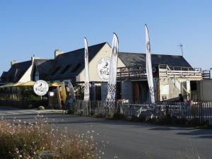 a building with a fence in front of it at les volets bleus in Saint-Guénolé