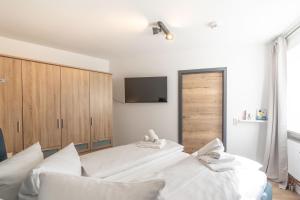 a bedroom with two beds and a flat screen tv at Berglust in Bad Hindelang +2 photos