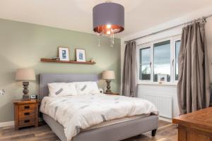 a bedroom with a bed and a large window at 15 Foster Crescent in Troon