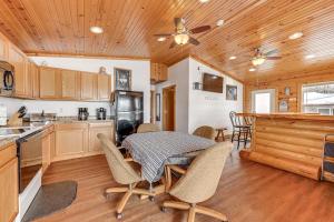 a kitchen and dining room with a table and chairs at Montello Cabin on Buffalo Lake with Dock and Fire Pit! in Montello