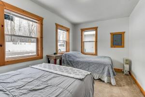 a bedroom with two beds and a window at Montello Cabin on Buffalo Lake with Dock and Fire Pit! in Montello