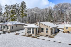 a house with snow on the ground in the yard at Montello Cabin on Buffalo Lake with Dock and Fire Pit! in Montello