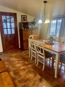 a dining room with a wooden table and chairs at Country relaxation in Naches