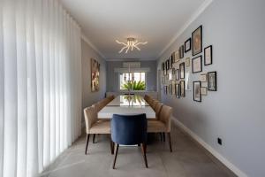 a dining room with a table and chairs at Spacious house with pool in Faro