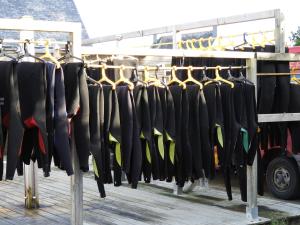 a bunch of umbrellas hanging on a rack at les volets bleus in Saint-Guénolé