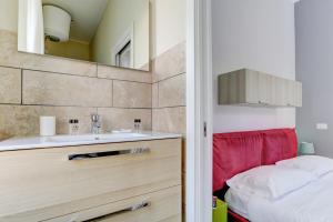 a bathroom with a sink and a mirror at Appartamento Santi Quattro - Colosseo in Rome