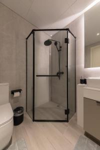 a shower with a glass door in a bathroom at Fresh & Quiet 1BR at Midtown Noor 4 Tower in Dubai