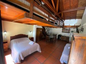 a bedroom with a bed and a table and chairs at San Remo Villa Corral Apart in Carilo